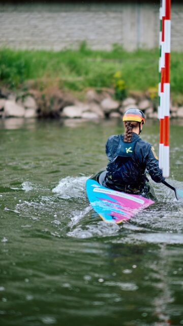 German Canoe Slalom Athlete Paddling Through Gates Mobile Wallpaper