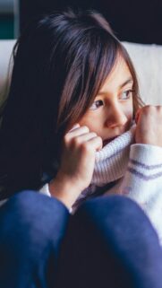Sad Young Girl in Cozy Knit Sweater Portrait Mobile Wallpaper