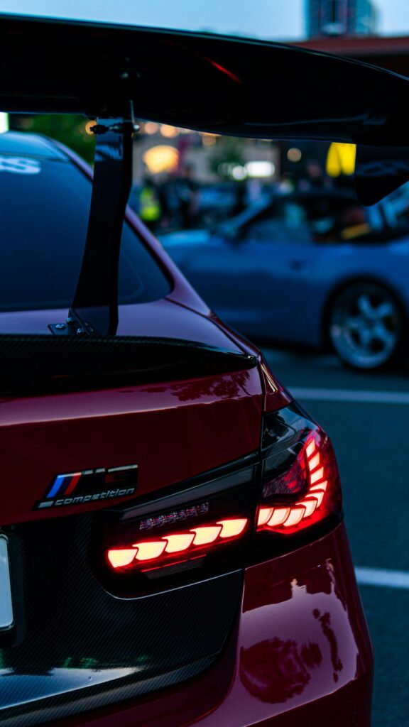 Red BMW M3 Competition Car Tail Light Close-up Phone Wallpaper