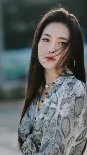 Elegant Asian Woman in Snake Print Shirt Portrait Mobile Wallpaper