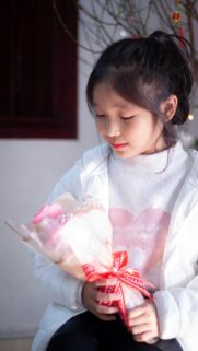 Cute Young Girl Holding a Bouquet of Flowers Aesthetic Wallpaper