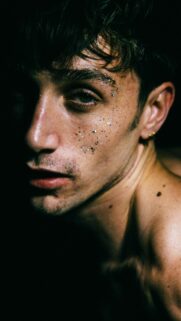Close-up Portrait of a Young Man with Glitter Face Art Wallpaper