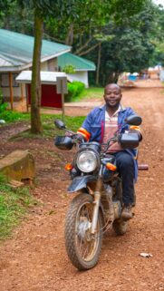 Man Riding Motorcycle on Dirt Road Portrait High Quality Wallpaper