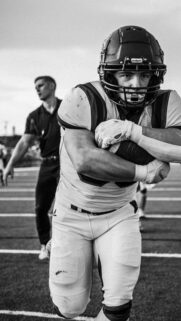 Gritty Football Player Focused Running Black and White Mobile Wallpaper