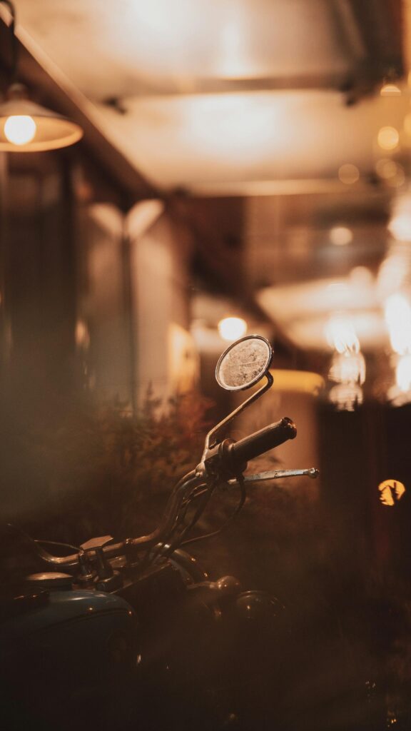 Vintage Motorcycle Handlebar and Mirror Night City Vibe Wallpaper