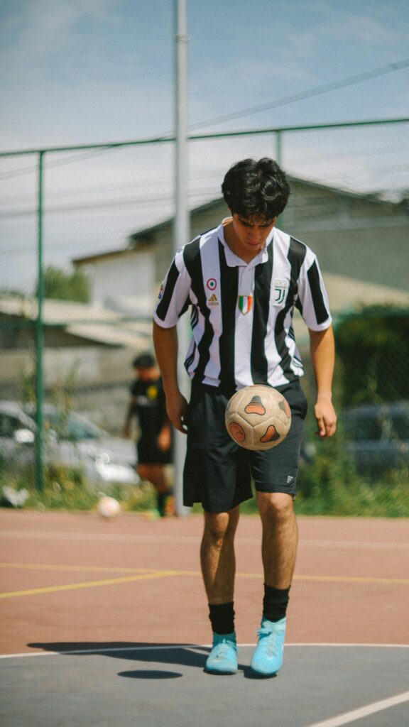 Juventus Football Player Dribbling Soccer Ball Phone Wallpaper