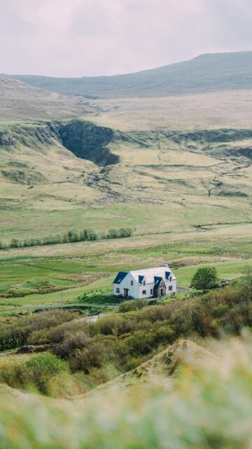 Picturesque Highland Cottage Nestled in Scottish Valley Wallpaper