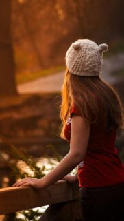 Girl in Bear Ear Beanie Hat Looking at Sunset Mobile Wallpaper