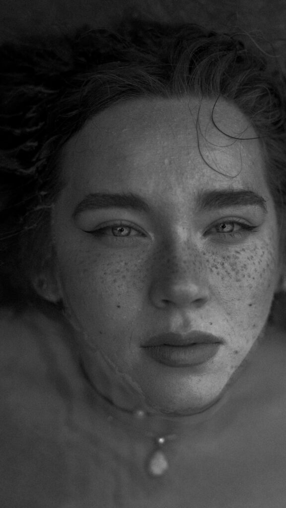 Stunning Close-Up Portrait of a Woman with Freckles Aesthetic Wallpaper
