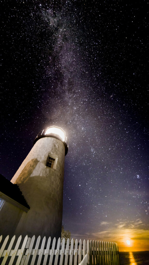 Celestial Guidance Lighthouse Under the Milky Way Spiritual Wallpaper