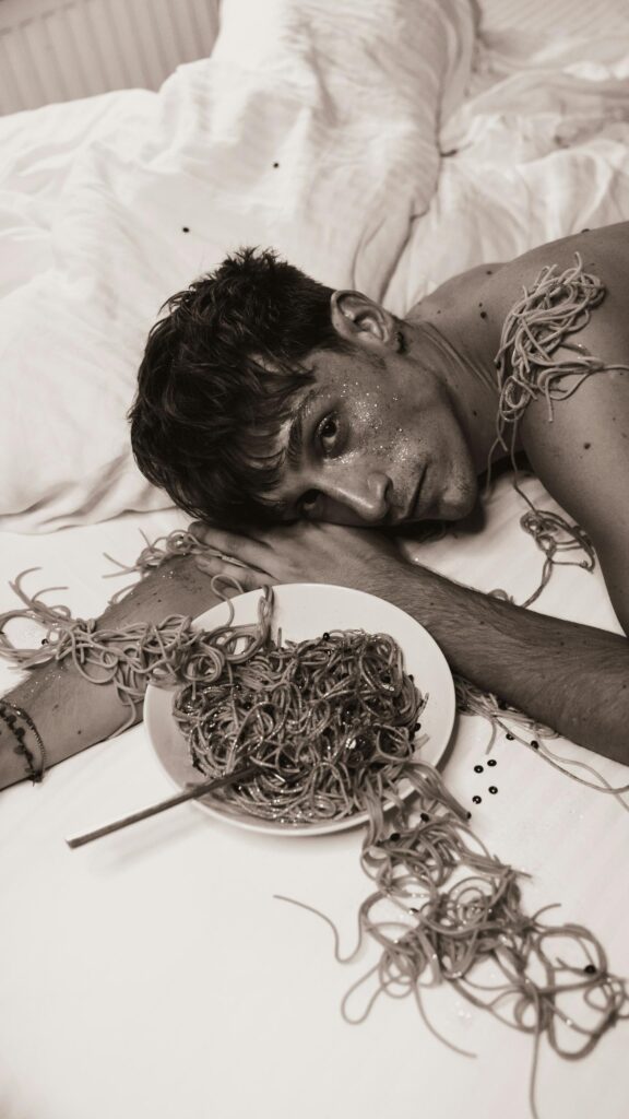 Young Man with Spaghetti and Glitter Surreal Artistic Phone Wallpaper