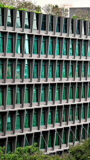Modern Architectural Facade with Geometric Green Windows Wallpaper
