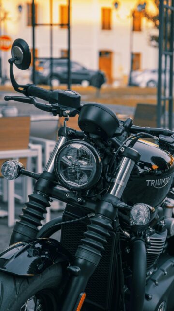 Elegant Black Triumph Motorcycle Close-up Mobile Wallpaper