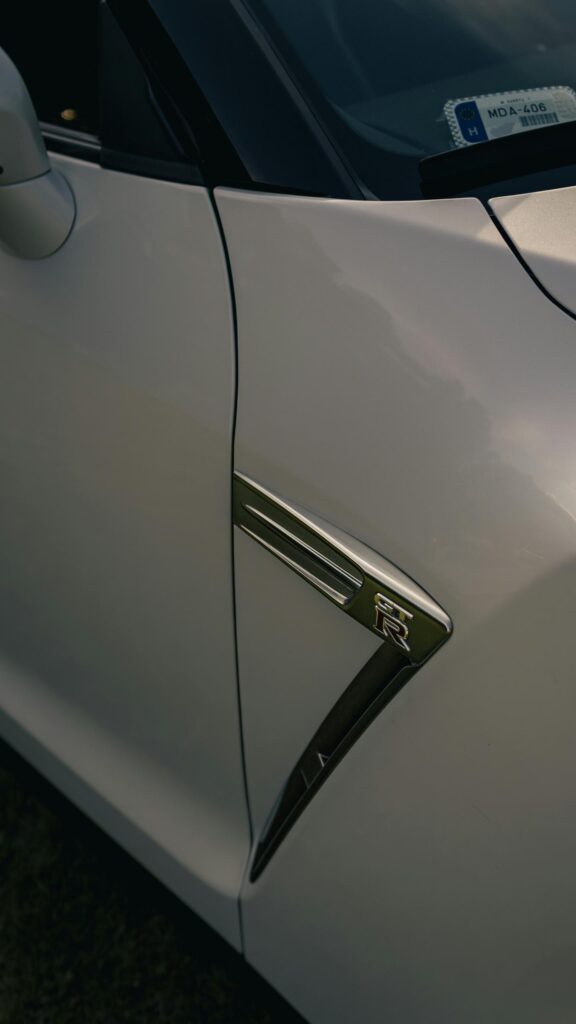 Nissan GT-R Fender Emblem Close-up White Sports Car Wallpaper