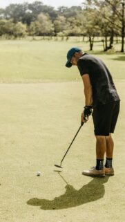 Professional Golfer Preparing for a Precision Putt Phone Wallpaper