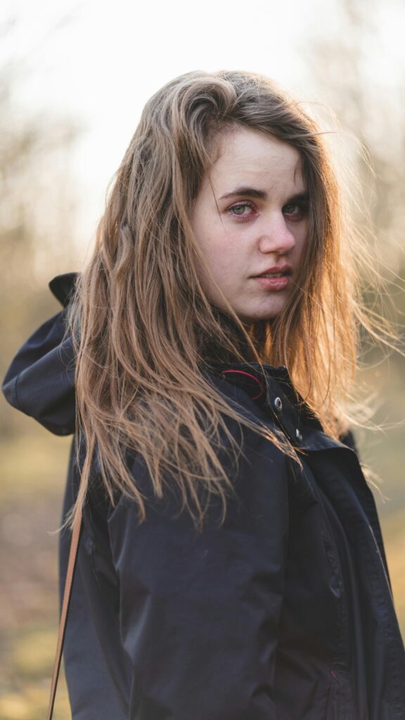 Portrait of a Beautiful Young Woman with Natural Flowing Hair Wallpaper
