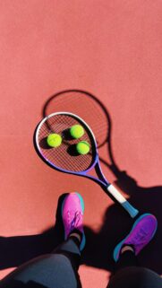 Tennis Player Court POV with Purple Racket and Balls Wallpaper