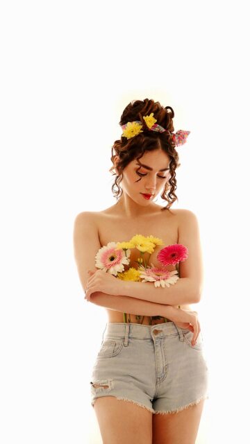 Stunning Young Woman with Flowers in Hair and Hands Mobile Wallpaper