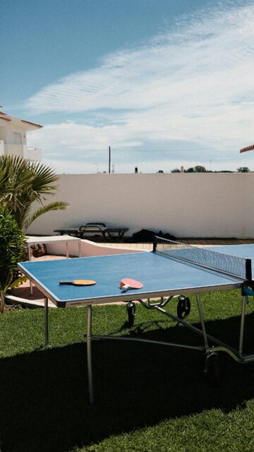 Ping Pong Table on Sunny Grass Lawn Phone Wallpaper
