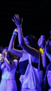 Concert Crowd Dancing Under Purple Lights Mobile Phone Wallpaper