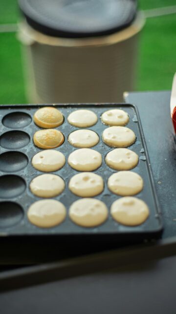 Freshly Baked Poffertjes on a Griddle Culinary Macro Mobile Wallpaper