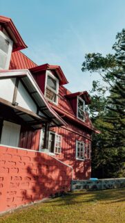 Charming Red Wooden Cottage House in Sunny Garden Landscape Wallpaper