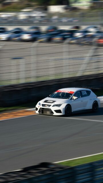 White Racing Cupra Car Speeding on Circuit Track Mobile Wallpaper