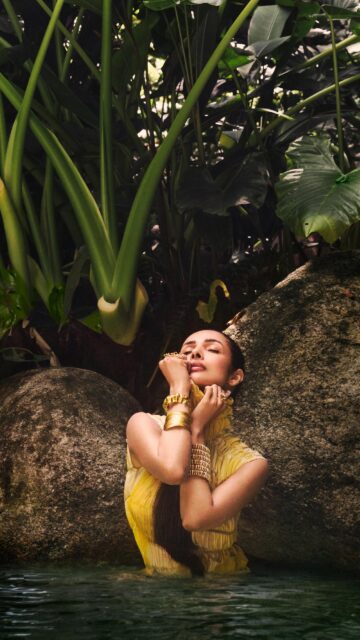 Malaika Arora in Tropical Yellow Dress Golden Jewelry Water Wallpaper
