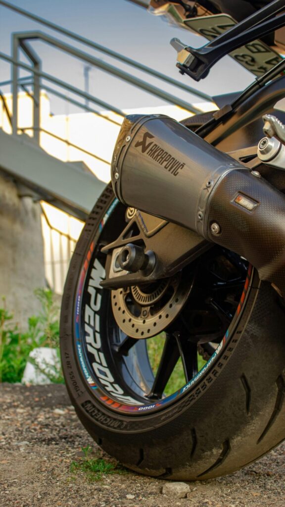 A closer look at Close Up BMW S1000RR Akrapovic Exhaust Motorcycle Wallpaper — strong contrast, clear shapes and just enough atmosphere for a daily wallpaper.
