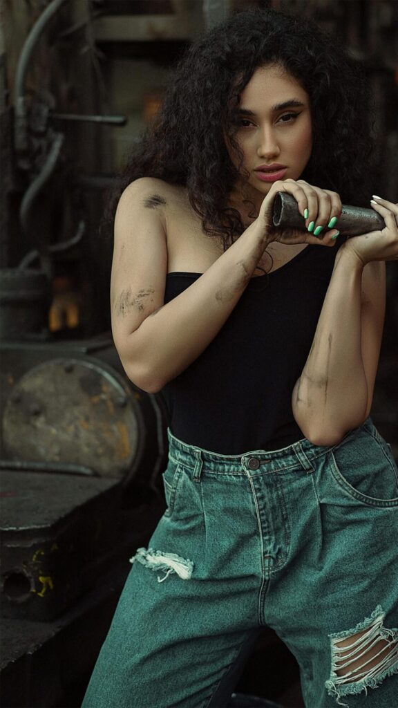 Stunning Industrial Beauty Portrait with Curly Hair Mobile Wallpaper turns a simple moment into something cinematic. This one works especially well on a dark lock screen.