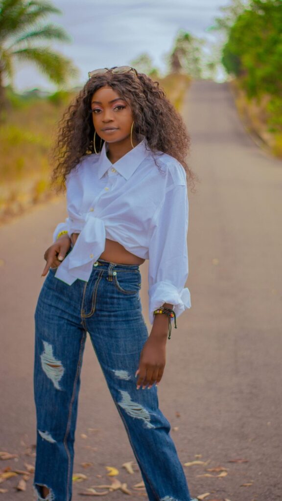 I love the negative space in Beautiful Woman in White Shirt and Ripped Jeans Mobile Wallpaper. It keeps the subject strong while staying practical as a wallpaper.