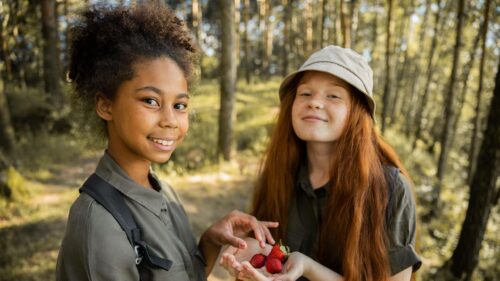 Two Friends Exploring Nature with Strawberries 4K Desktop Wallpaper