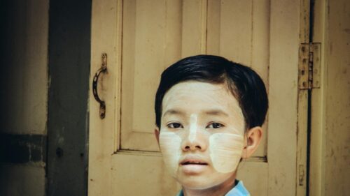 Portrait of a Burmese Child with Traditional Thanaka Face Paint Desktop Wallpaper