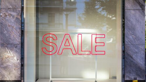 Bright Red Neon SALE Sign on Storefront Window 4K Wallpaper