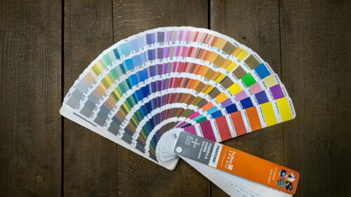 Vibrant Pantone Color Swatch Fan on Rustic Wood Desktop Wallpaper