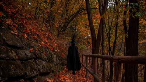 Mysterious Witch in Autumn Forest Path 4K Desktop Wallpaper