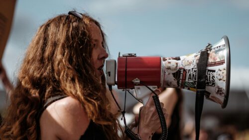 Activist Speaking Through Megaphone at Protest 4K Wallpaper