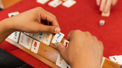 Hands Playing Okey Game with Numbered Tiles 4K Desktop Wallpaper