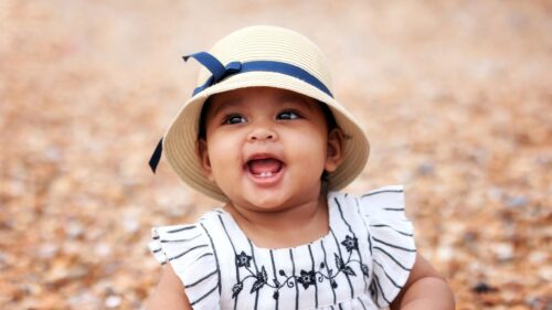 Adorable Baby Girl in Sun Hat Smiling Desktop Wallpaper
