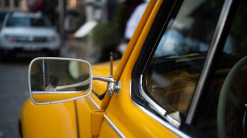 Classic Vintage Yellow Beetle Car Side Mirror Close-up 4K Wallpaper