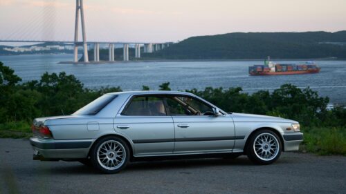 Silver Nissan Laurel JDM Car by the Sea Bridge 4K Wallpaper
