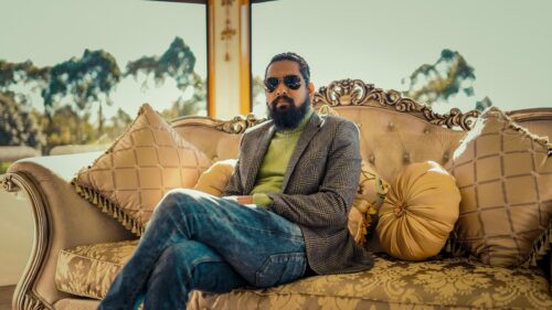 Stylish Man Sitting on Luxury Sofa Portrait Desktop Wallpaper