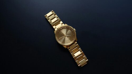 Elegant Gold Wristwatch on Dark Background 4K Wallpaper