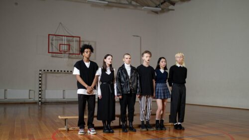 Diverse Fashion Models Standing in a Gymnasium 4K Wallpaper