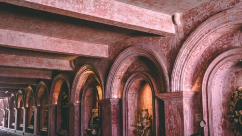 Ancient Temple Corridor with Stone Sculptures 4K Desktop Wallpaper