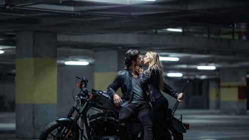 Couple in Leather Jackets on a Motorcycle in Parking Garage 4K Wallpaper