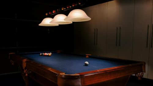 Billiards Table with Pool Balls and Dim Lighting 4K Desktop Wallpaper