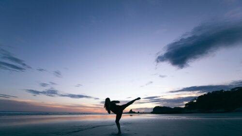 Martial Arts Kick Silhouette on Beach at Sunset Desktop Wallpaper