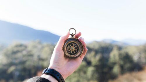 Hand Holding Vintage Compass in Nature 4K Desktop Wallpaper