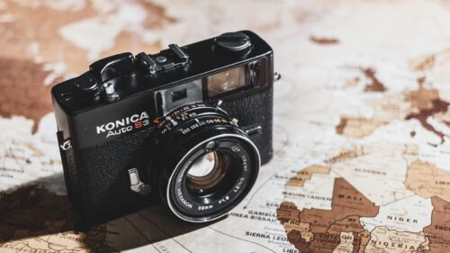 Vintage Konica Auto S3 Film Camera on World Map 4K Wallpaper
